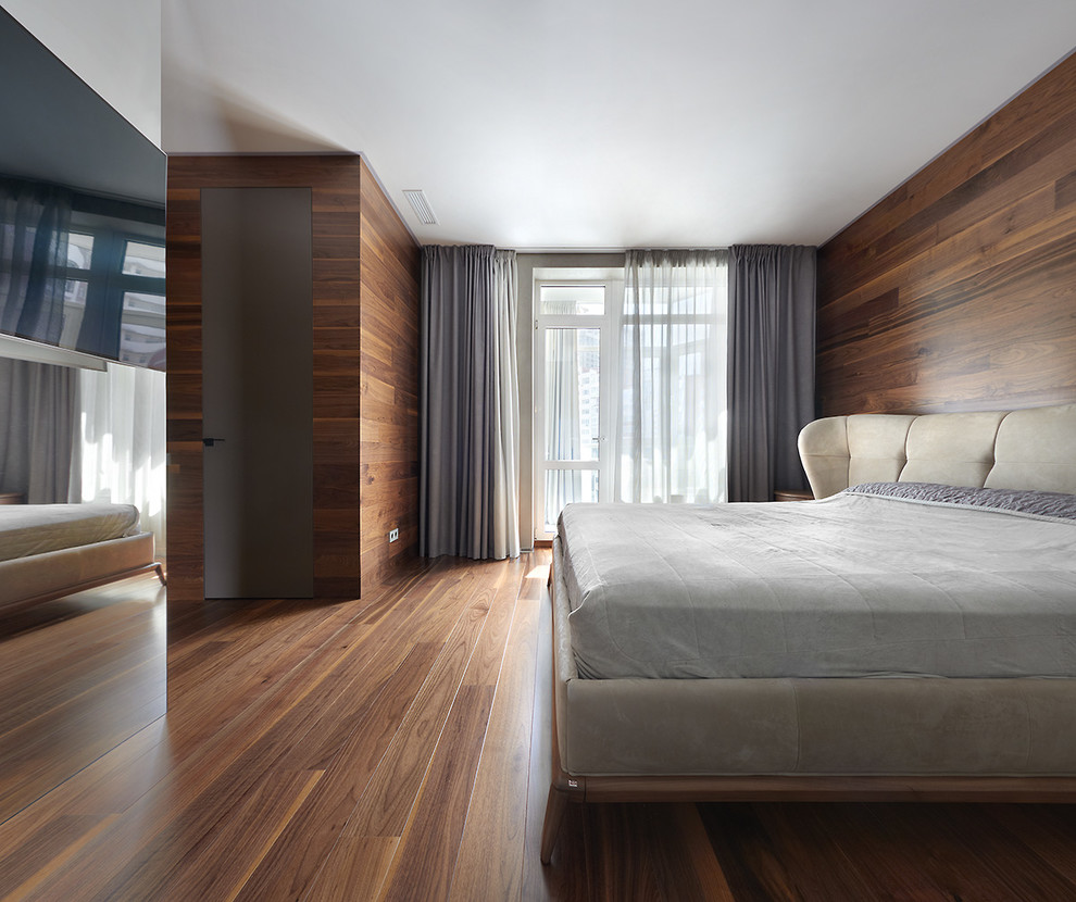 Design ideas for a large contemporary master bedroom in Los Angeles with brown walls, medium hardwood floors and brown floor.