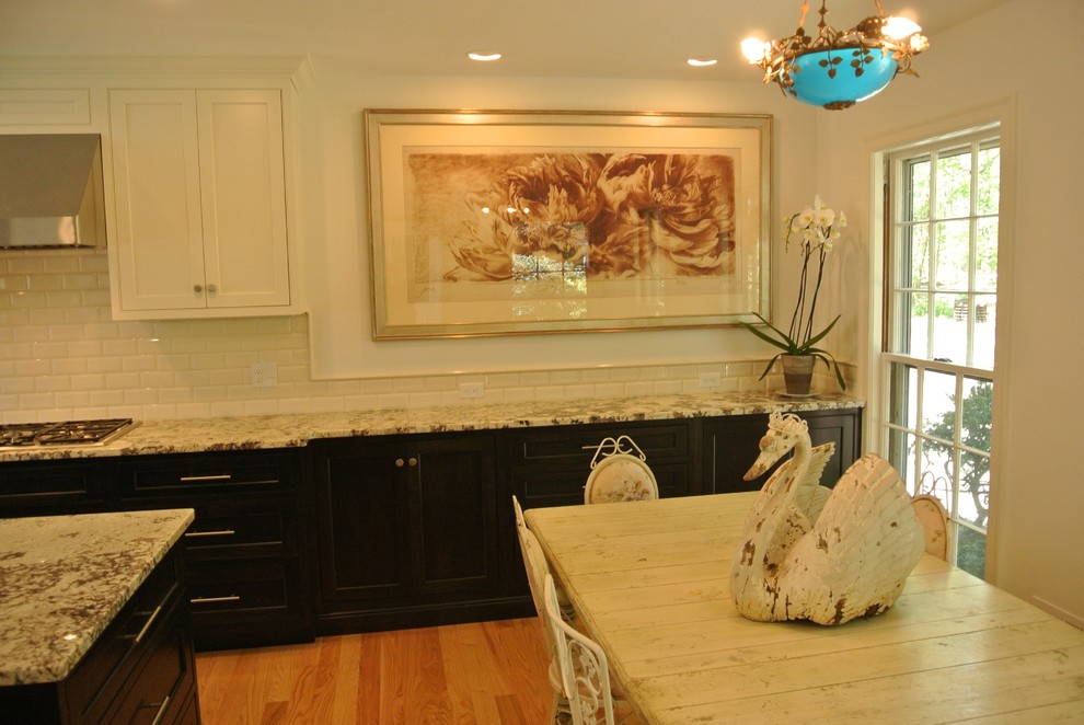 Inspiration for a transitional light wood floor eat-in kitchen remodel in Boston with an undermount sink, shaker cabinets, granite countertops, white backsplash, subway tile backsplash, stainless steel appliances and an island