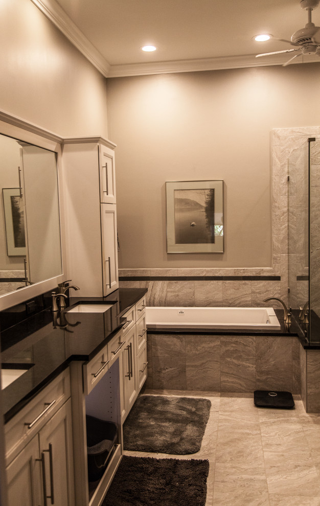 Inspiration for a mid-sized transitional master gray tile and ceramic tile marble floor, gray floor and double-sink drop-in bathtub remodel with shaker cabinets, white cabinets, a two-piece toilet, gray walls, an undermount sink, quartzite countertops, a hinged shower door, black countertops, a niche and a floating vanity