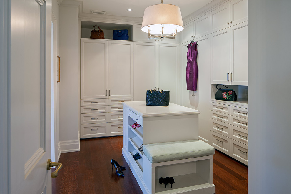 This is an example of a traditional walk-in wardrobe in Toronto with white cabinets.