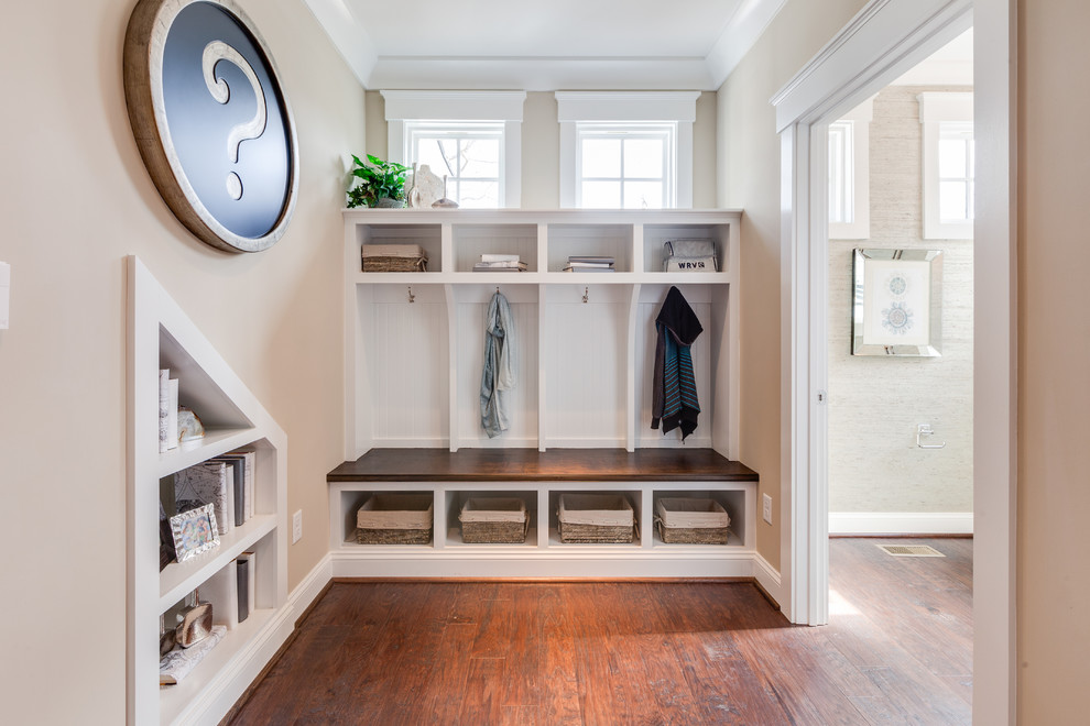 Photo of a large beach style mudroom in Other with beige walls and medium hardwood floors.