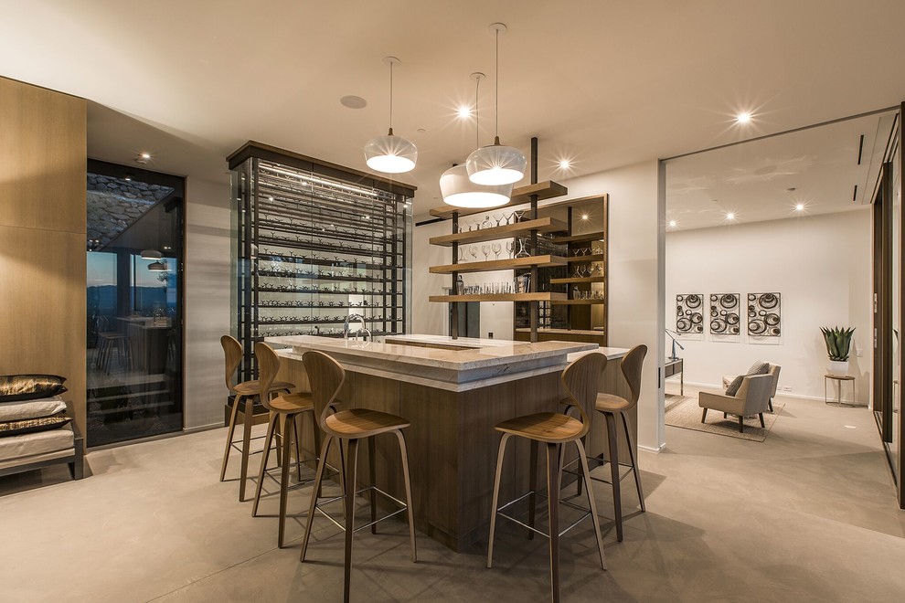 Inspiration for a large modern l-shaped seated home bar in Las Vegas with open cabinets, concrete floors, grey floor and beige benchtop.