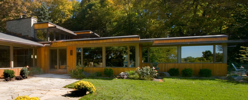 This is an example of a midcentury exterior in Minneapolis with wood siding.