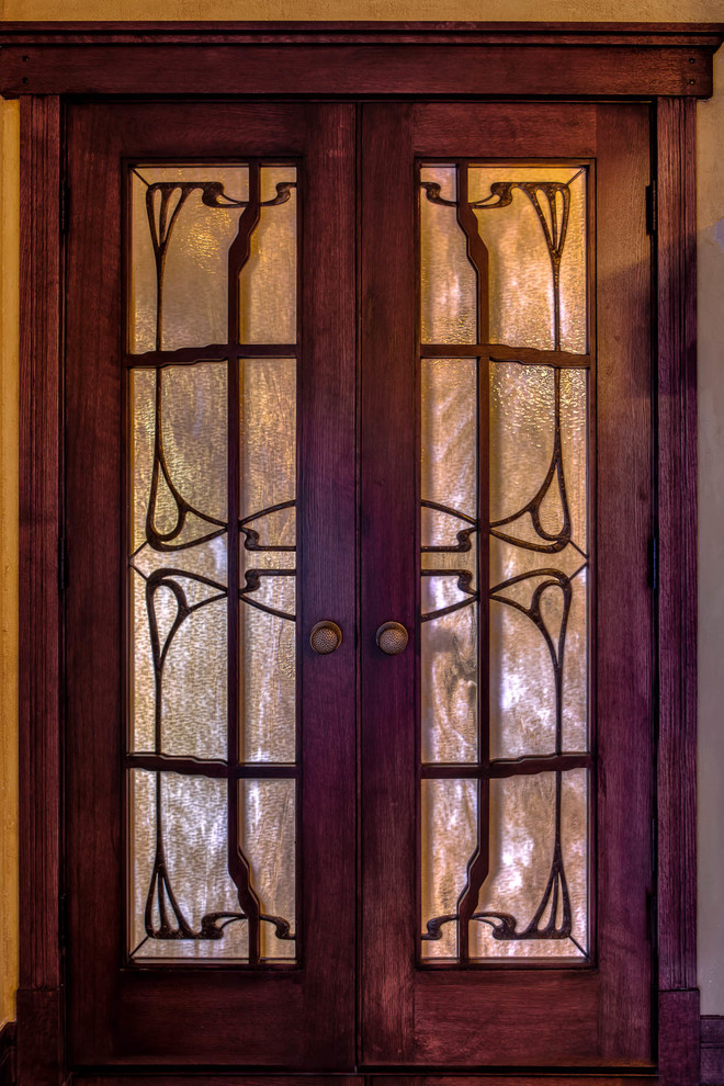 Inspiration for a transitional kitchen remodel in Denver with glass-front cabinets and dark wood cabinets