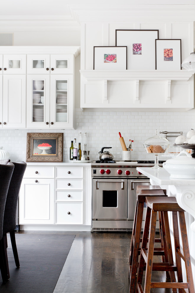 Design ideas for a traditional kitchen in New York with recessed-panel cabinets, white cabinets, white splashback, subway tile splashback and stainless steel appliances.