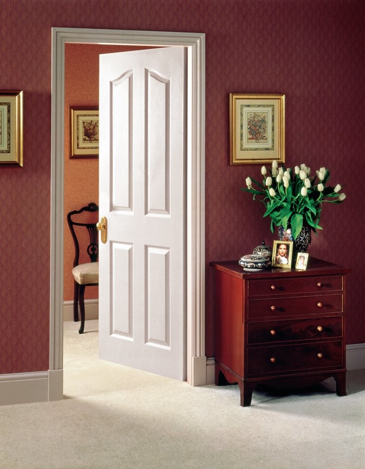 Photo of a mid-sized traditional master bedroom in Other with red walls, carpet, no fireplace and beige floor.