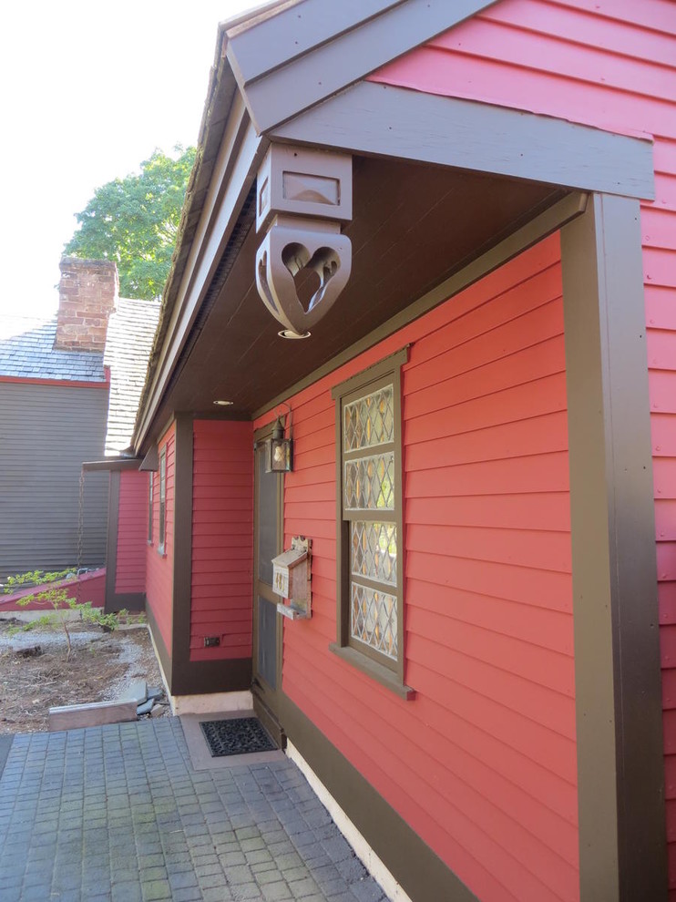 This is an example of a mid-sized country two-storey red house exterior in New York with wood siding, a gable roof and a shingle roof.