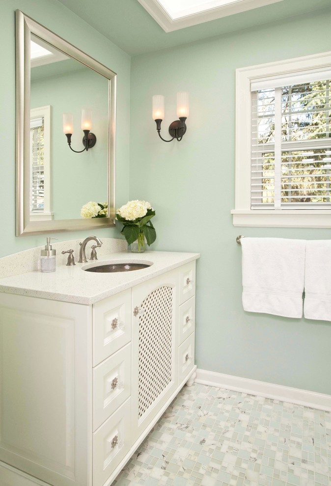 Inspiration for a small traditional kids bathroom in Seattle with an undermount sink, raised-panel cabinets, white cabinets, engineered quartz benchtops, an alcove tub, an alcove shower, a two-piece toilet, white tile, subway tile, green walls and marble floors.
