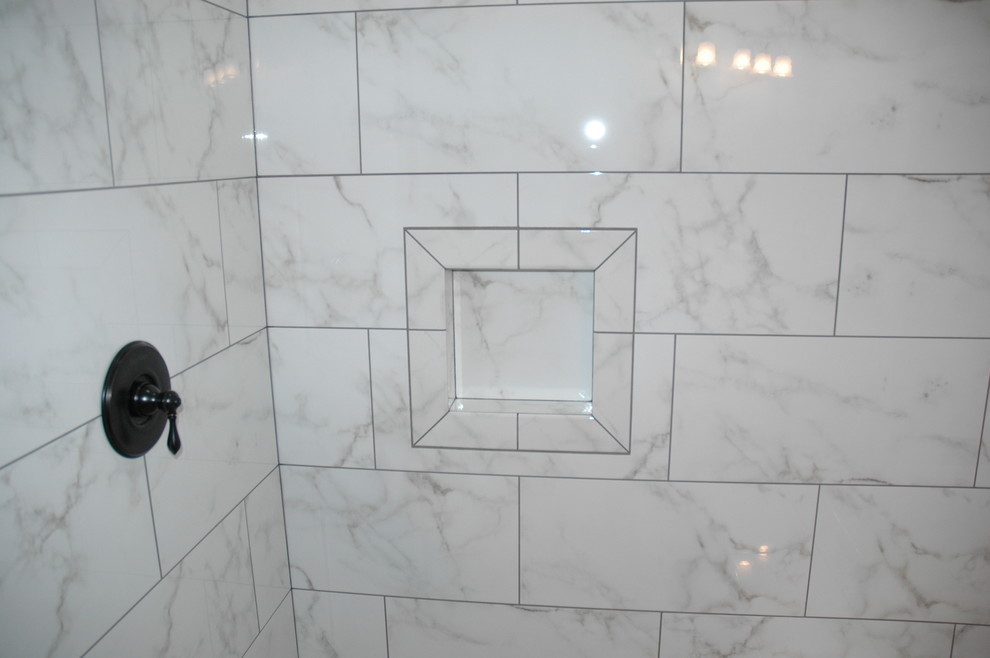 Photo of a mid-sized modern master bathroom in Other with an undermount sink, shaker cabinets, dark wood cabinets, marble benchtops, a drop-in tub, an open shower, a two-piece toilet, white tile, porcelain tile, white walls and porcelain floors.