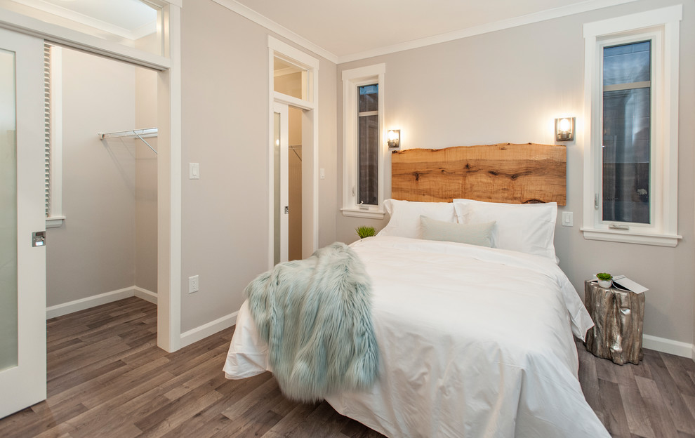 Example of a small transitional master vinyl floor and multicolored floor bedroom design with beige walls