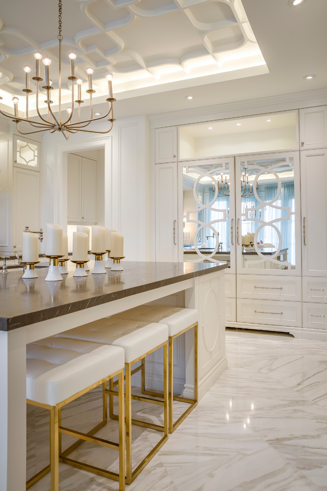 This is an example of a large modern single-wall separate kitchen in Toronto with a double-bowl sink, raised-panel cabinets, white cabinets, marble benchtops, black splashback, stone slab splashback, panelled appliances, marble floors and with island.