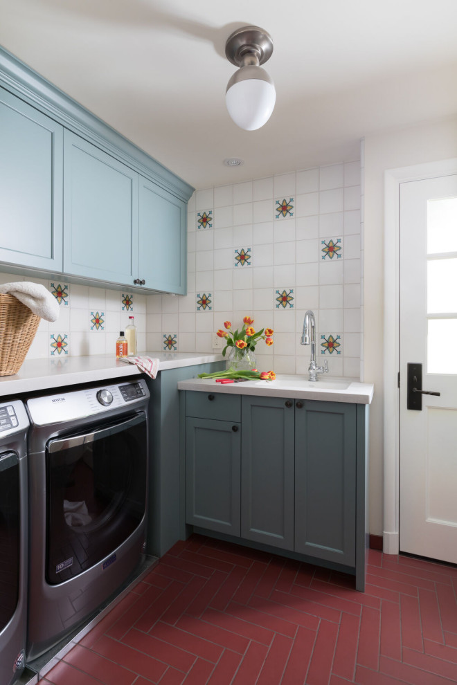 This is an example of a transitional laundry room in San Francisco with white splashback, multi-coloured walls, ceramic floors and red floor.