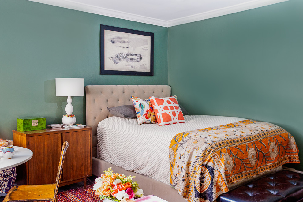 This is an example of a mid-sized eclectic master bedroom in New York with green walls, dark hardwood floors and brown floor.