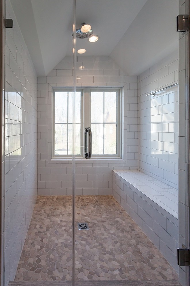 This is an example of a country bathroom in DC Metro with an alcove shower, white tile, subway tile, grey walls, a trough sink, brown floor, a hinged shower door and pebble tile floors.