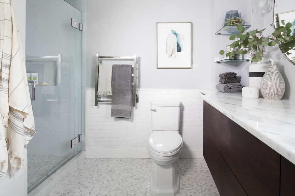 Design ideas for a mid-sized transitional wet room bathroom in Seattle with flat-panel cabinets, dark wood cabinets, a one-piece toilet, white tile, ceramic tile, grey walls, marble floors, a trough sink, quartzite benchtops, a hinged shower door, grey benchtops, a niche, a single vanity and a floating vanity.