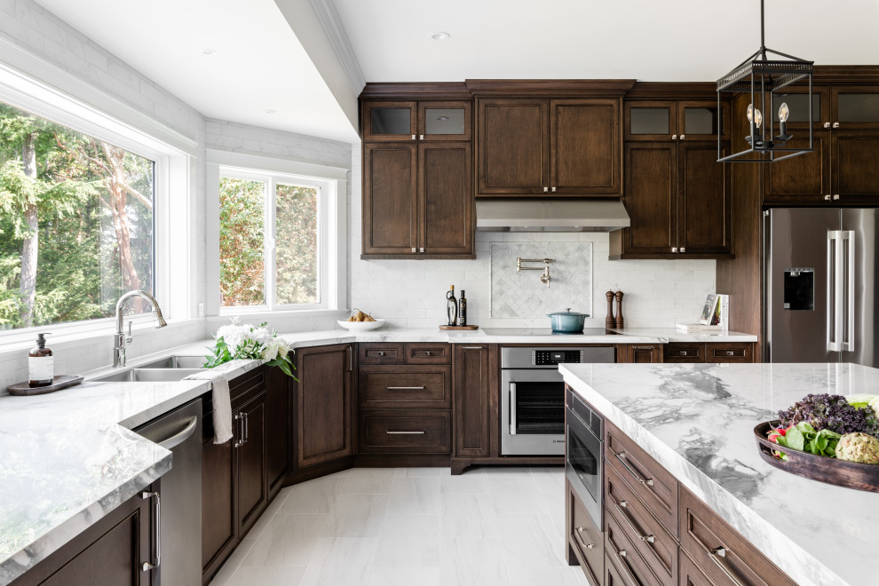 Open concept kitchen - large transitional u-shaped porcelain tile and white floor open concept kitchen idea in Vancouver with an undermount sink, recessed-panel cabinets, dark wood cabinets, quartz countertops, white backsplash, ceramic backsplash, stainless steel appliances, an island and white countertops