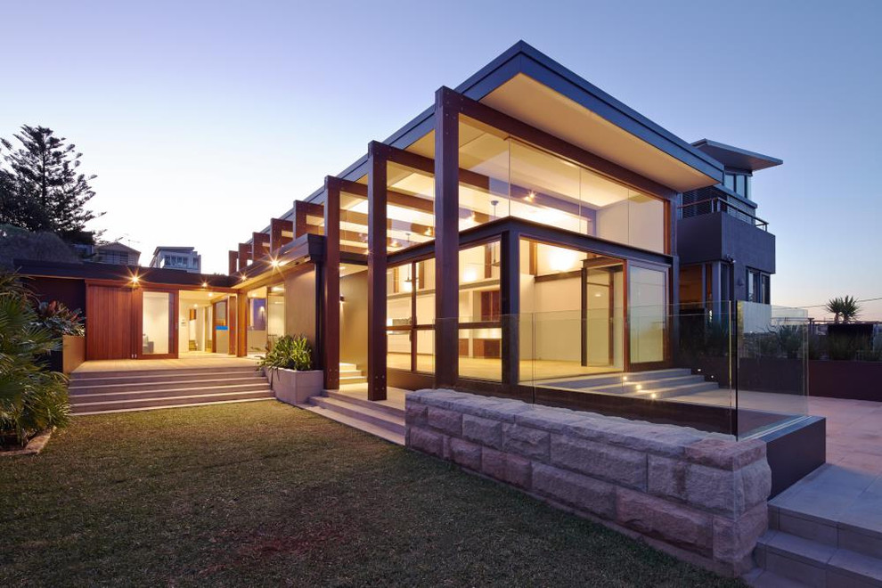 Design ideas for a large modern split-level black exterior in Sydney with wood siding and a flat roof.