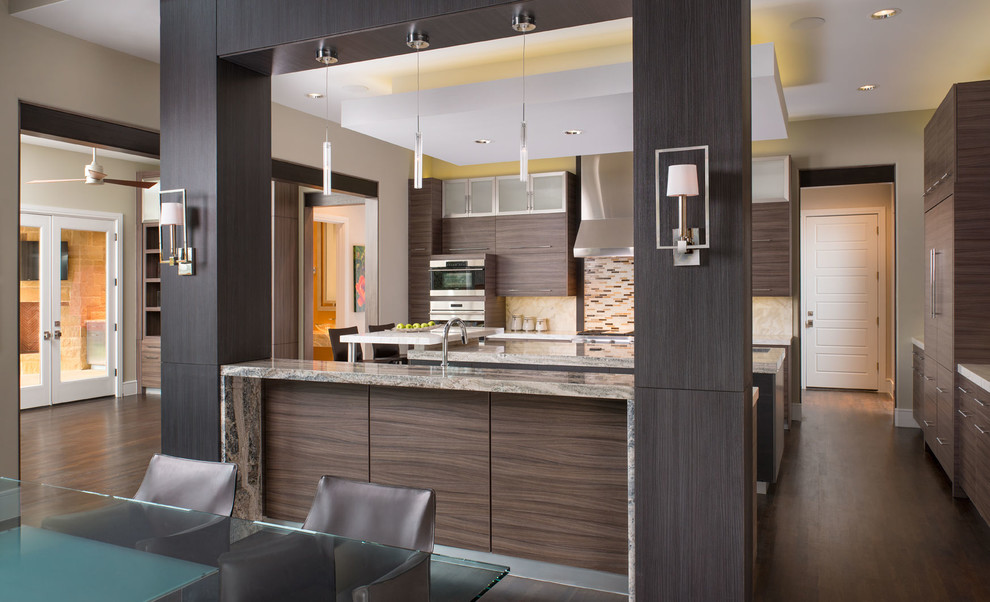 Inspiration for an expansive contemporary u-shaped eat-in kitchen in Dallas with a double-bowl sink, flat-panel cabinets, dark wood cabinets, marble benchtops, brown splashback, mosaic tile splashback, dark hardwood floors, with island and stainless steel appliances.