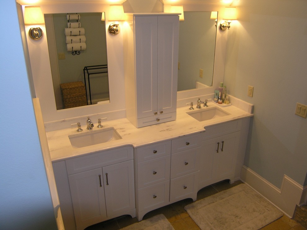 This is an example of a mid-sized transitional master bathroom in Tampa with shaker cabinets, white cabinets, an alcove tub, an alcove shower, a one-piece toilet, white tile, porcelain tile, blue walls, travertine floors, an undermount sink and marble benchtops.