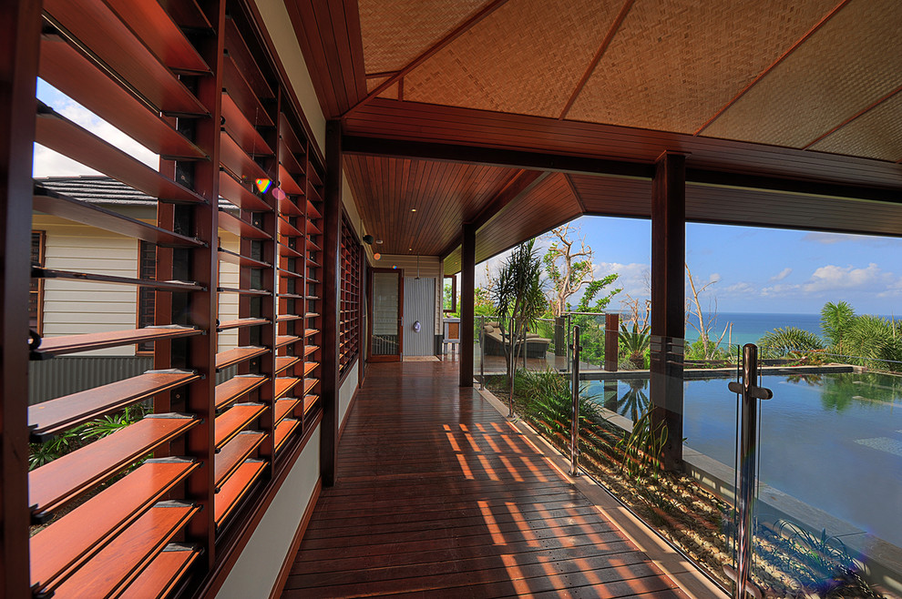 This is an example of a tropical deck in Cairns with a roof extension.