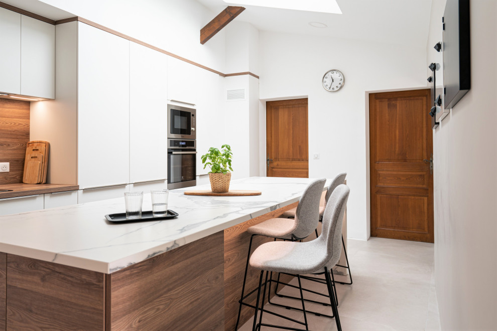 Design ideas for a large scandi l-shaped enclosed kitchen in Other with a submerged sink, flat-panel cabinets, white cabinets, marble worktops, brown splashback, wood splashback, integrated appliances, concrete flooring, an island, grey floors, white worktops and exposed beams.