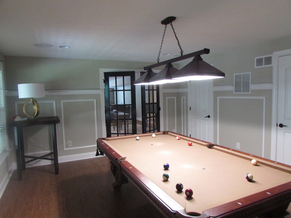 Inspiration for a large transitional walk-out vinyl floor basement remodel with beige walls, a standard fireplace and a stone fireplace
