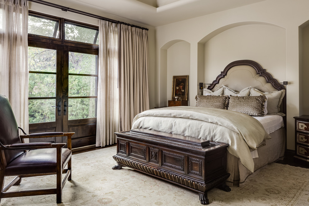 This is an example of a mediterranean bedroom in San Francisco with beige walls and beige floor.