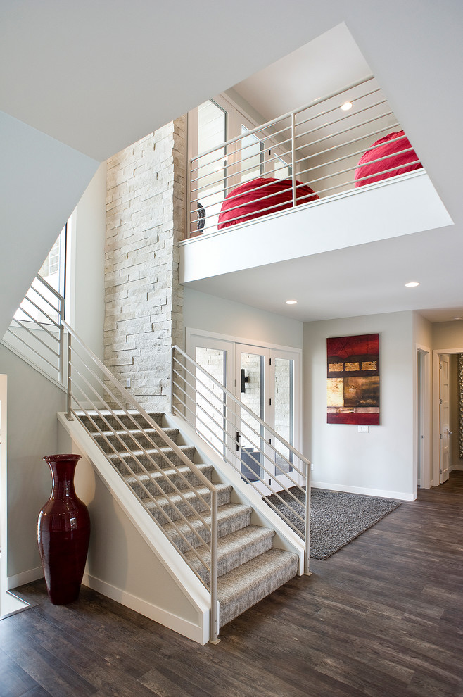 Inspiration for a mid-sized modern dark wood floor and brown floor foyer remodel with gray walls and a white front door