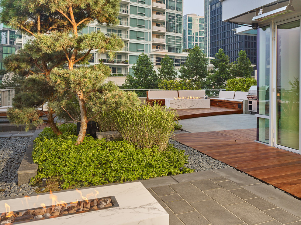 Design ideas for a large contemporary courtyard patio in Vancouver with a fire feature, concrete pavers and no cover.