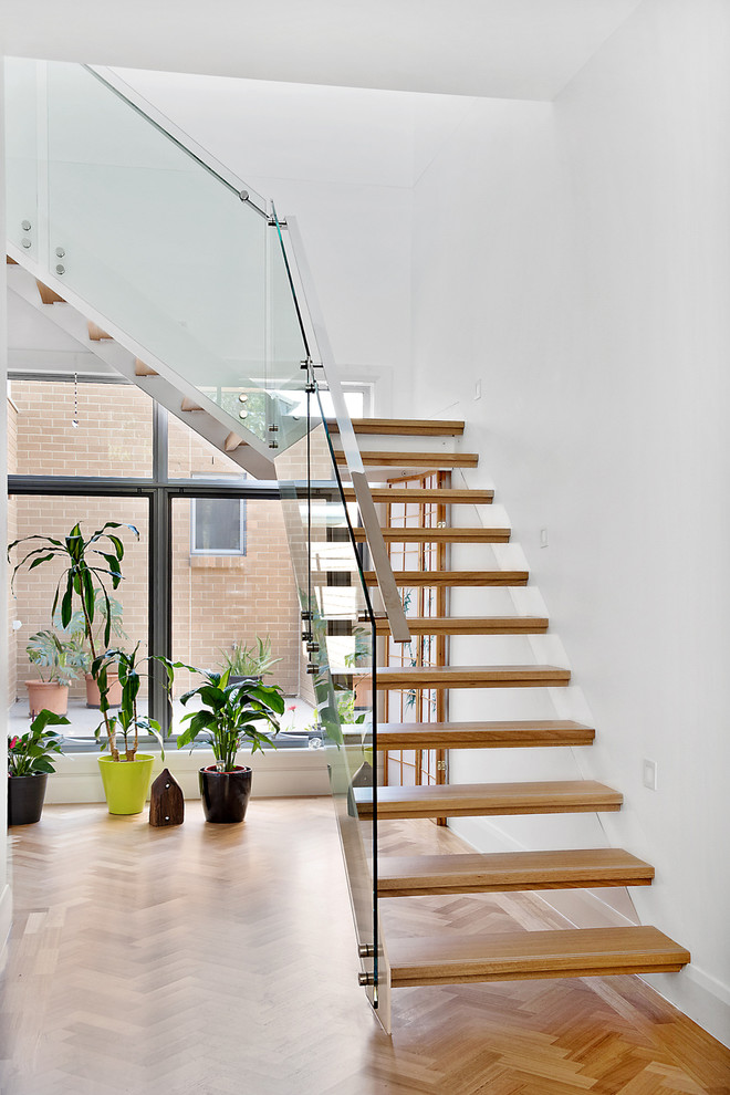 This is an example of a mid-sized contemporary wood staircase in Adelaide with open risers.