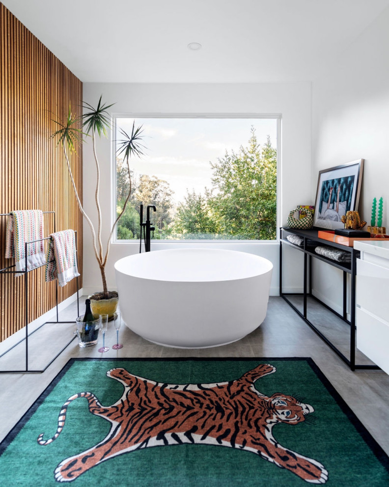 Large modern ensuite bathroom in San Francisco with flat-panel cabinets, white cabinets, a freestanding bath, a corner shower, a one-piece toilet, white tiles, ceramic tiles, white walls, ceramic flooring, a vessel sink, a hinged door, double sinks, a floating vanity unit and wood walls.