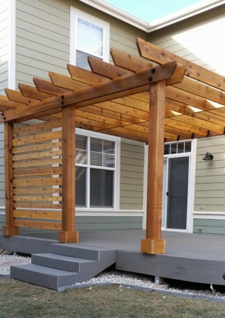 Photo of a large traditional backyard patio in Denver with a pergola and natural stone pavers.