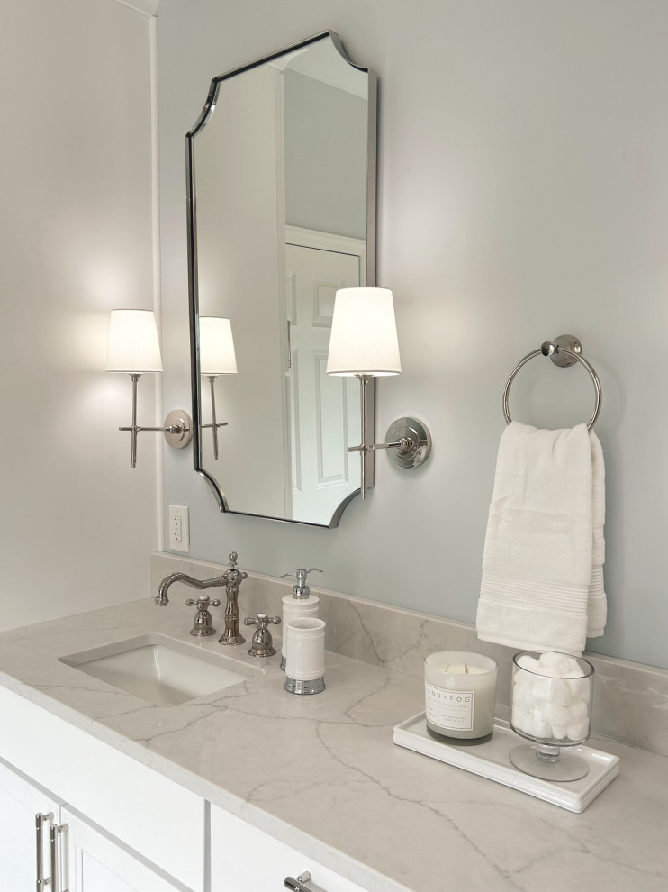 Mid-sized transitional master gray tile and marble tile marble floor, gray floor, double-sink and wainscoting freestanding bathtub photo with shaker cabinets, white cabinets, a two-piece toilet, blue walls, an undermount sink, quartz countertops, a hinged shower door, gray countertops and a built-in vanity