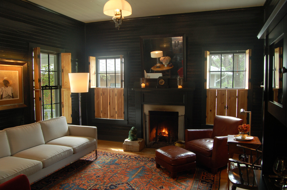 Inspiration for a country living room in Austin with black walls.
