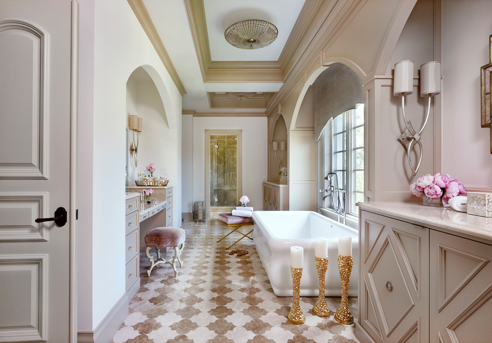 Design ideas for a traditional bathroom in Tampa with beige cabinets, a freestanding tub, white walls and beige floor.