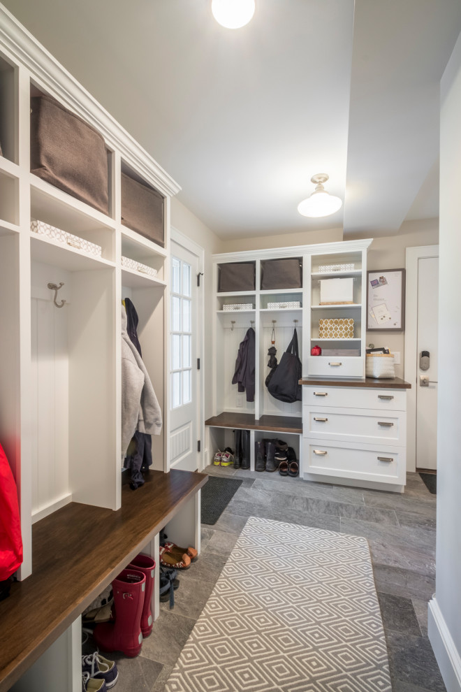 Design ideas for a large transitional mudroom in Minneapolis with a single front door, a white front door and grey floor.
