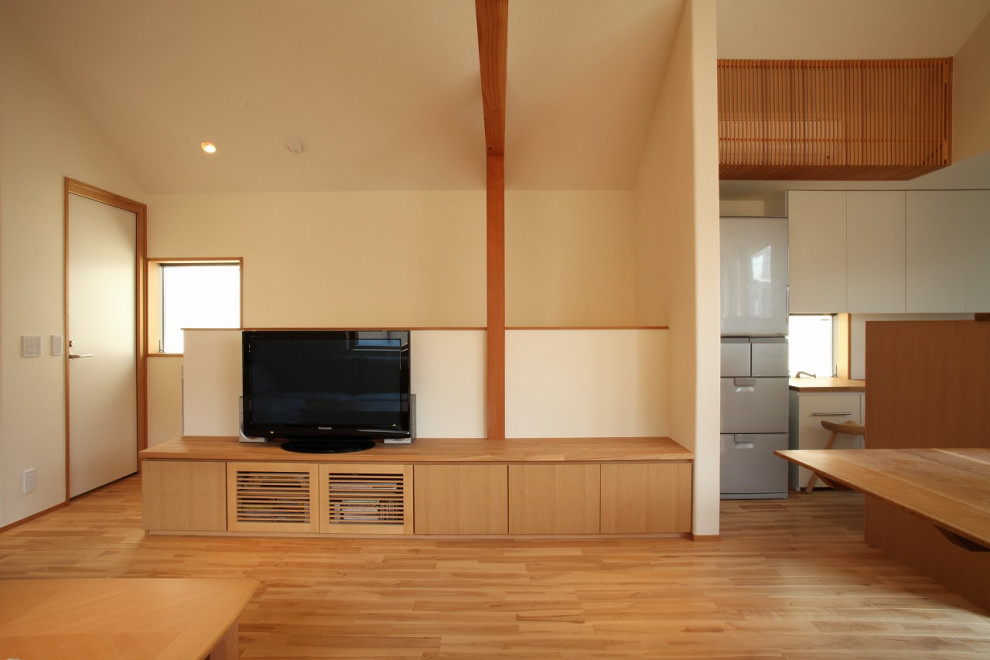 Inspiration for a mid-sized modern formal open concept living room in Tokyo with white walls, medium hardwood floors, no fireplace, a freestanding tv and brown floor.