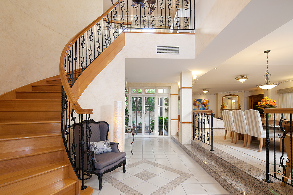 This is an example of a large mediterranean foyer in Brisbane with beige walls, ceramic floors, a double front door and a white front door.
