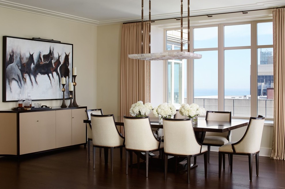 Inspiration for a transitional dining room in New York with beige walls and dark hardwood floors.