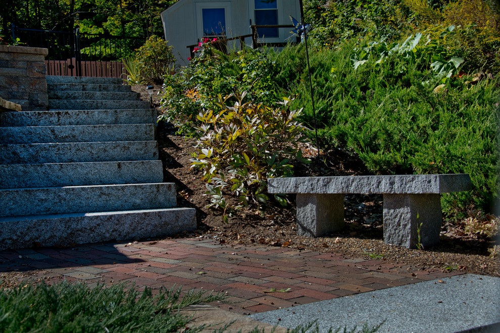 This is an example of a rustic front yard concrete paver driveway in Boston.
