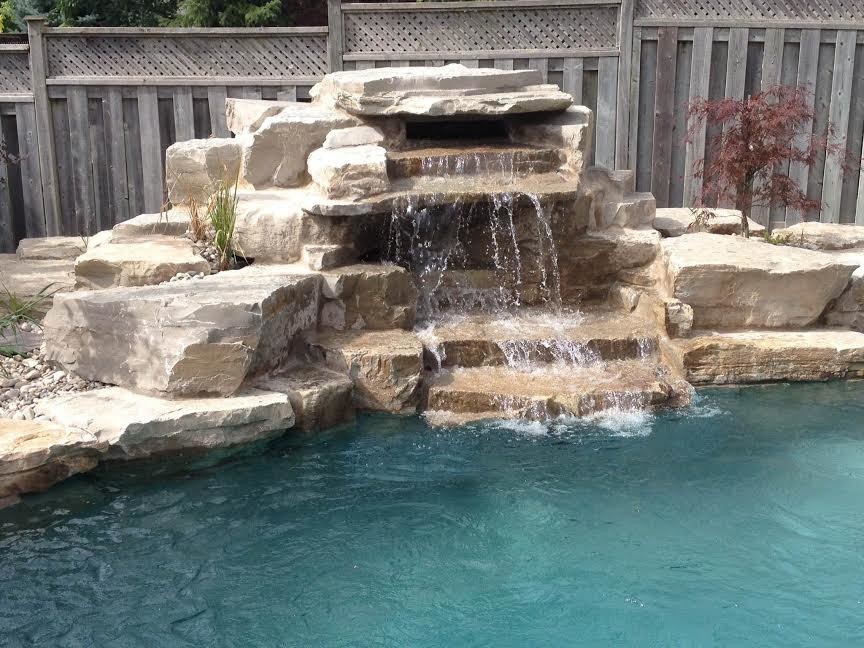 Pool fountain - mid-sized transitional backyard stamped concrete and custom-shaped natural pool fountain idea in Toronto