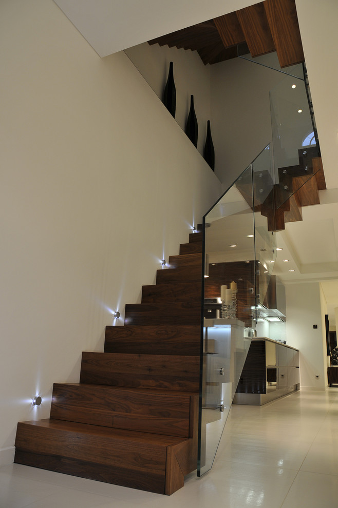 Contemporary wood staircase in London with wood risers.