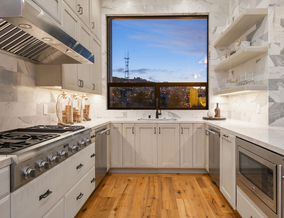 Kitchen - transitional u-shaped medium tone wood floor and brown floor kitchen idea in San Francisco with an undermount sink, shaker cabinets, gray cabinets, gray backsplash, stainless steel appliances, no island and white countertops