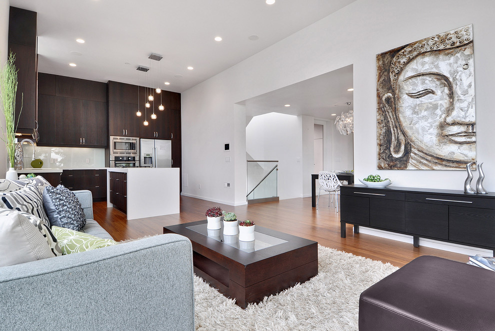Photo of a contemporary open concept family room in Vancouver with white walls and medium hardwood floors.
