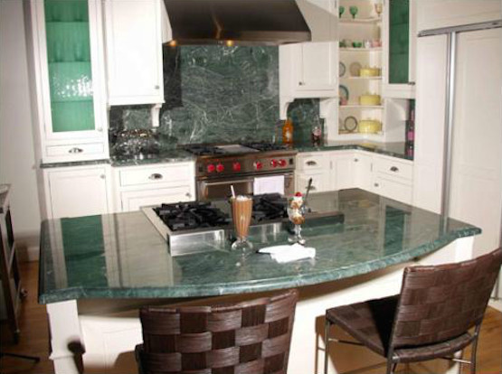 Transitional l-shaped light wood floor eat-in kitchen photo in Cincinnati with recessed-panel cabinets, white cabinets, granite countertops, green backsplash, stone slab backsplash, stainless steel appliances and an island