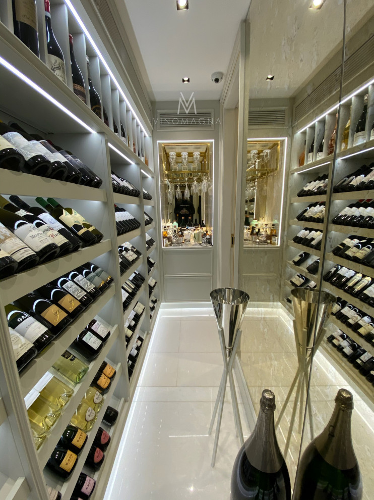 Expansive modern wine cellar in London with display racks.