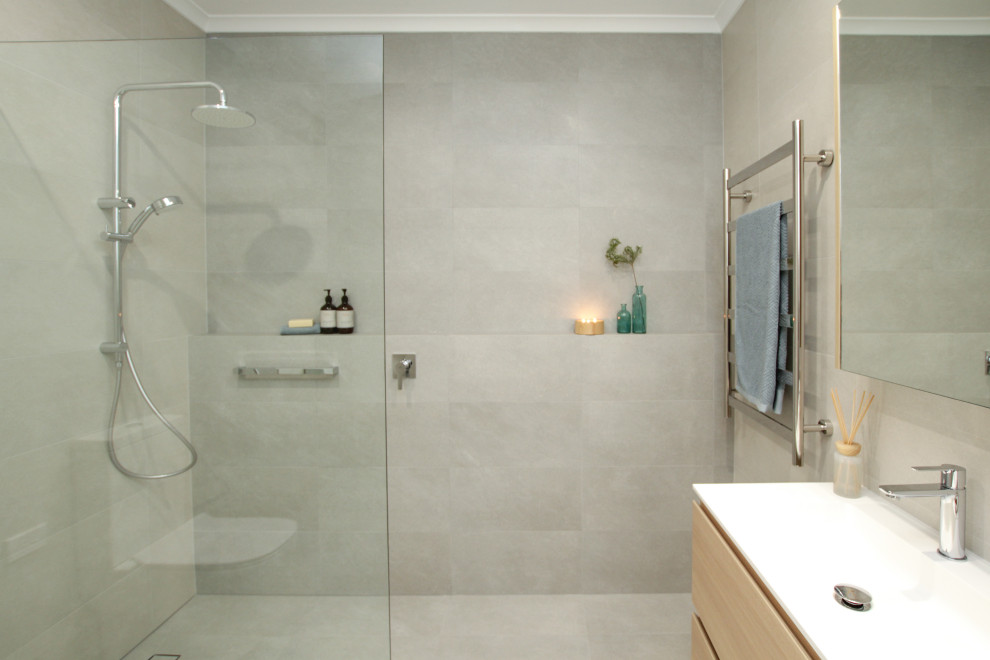 Inspiration for a large modern 3/4 bathroom in Sydney with light wood cabinets, an open shower, a two-piece toilet, gray tile, grey walls, an integrated sink, grey floor, an open shower, white benchtops, a double vanity and a freestanding vanity.