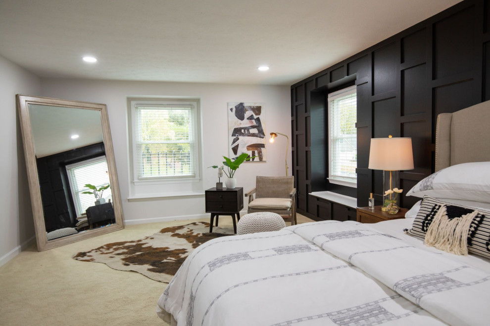 Photo of a large transitional master bedroom in Indianapolis with black walls, carpet, beige floor and panelled walls.