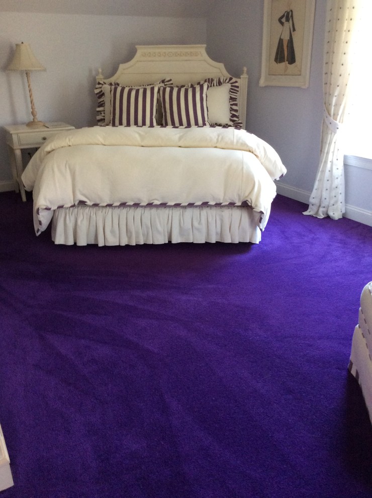 This is an example of a mid-sized traditional master bedroom in New York with brown walls, carpet, no fireplace and purple floor.