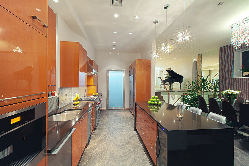 Large modern galley open plan kitchen in New York with a double-bowl sink, flat-panel cabinets, orange cabinets, quartz benchtops, multi-coloured splashback, mosaic tile splashback, stainless steel appliances and with island.